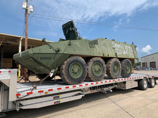 Crest Transportation heavy equipment positioned on an open-deck trailer